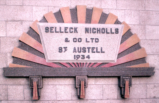 Art deco plaque commemorating the move to their new premises in Par Moor Road, St Austell.